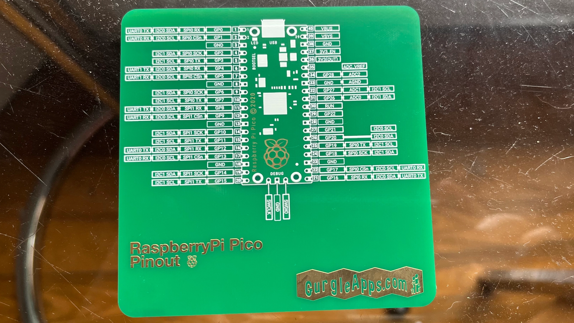 raspberry pi pico pinout coaster electronic pcb on glass table