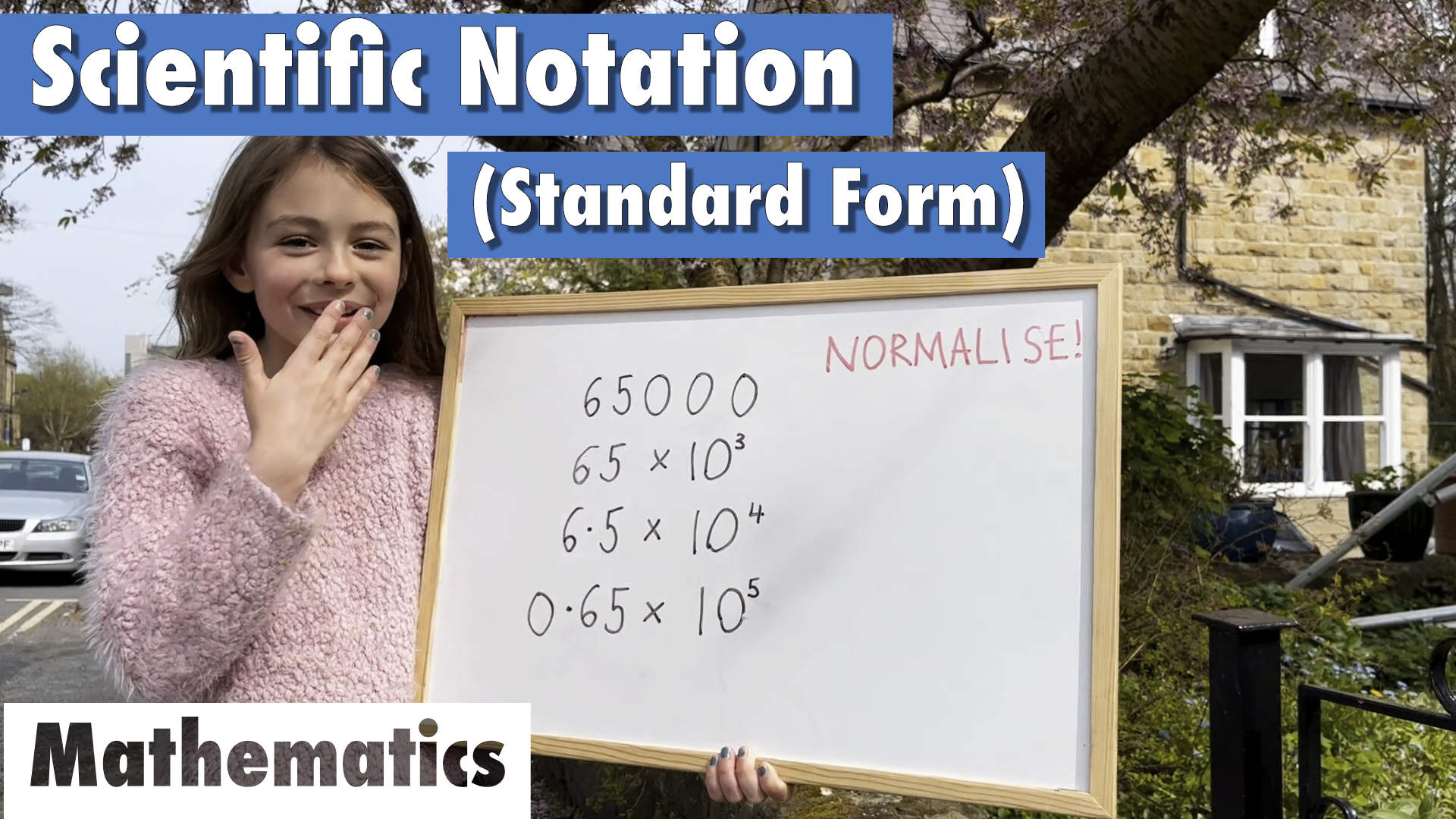 girl explaining scientific notation or standard form on a whiteboard